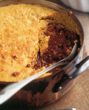 Foto de chili com carne sob uma cobertura de pão de milho