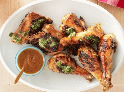 Foto de um frango de churrasco com pimenta chipotle, manga e molho chimichurri