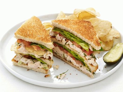 Sanduíche de clube fotográfico com frango, salada e batatas fritas